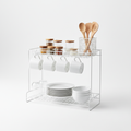 Kitchen cabinet shelf riser with two tiers holding plates and mugs